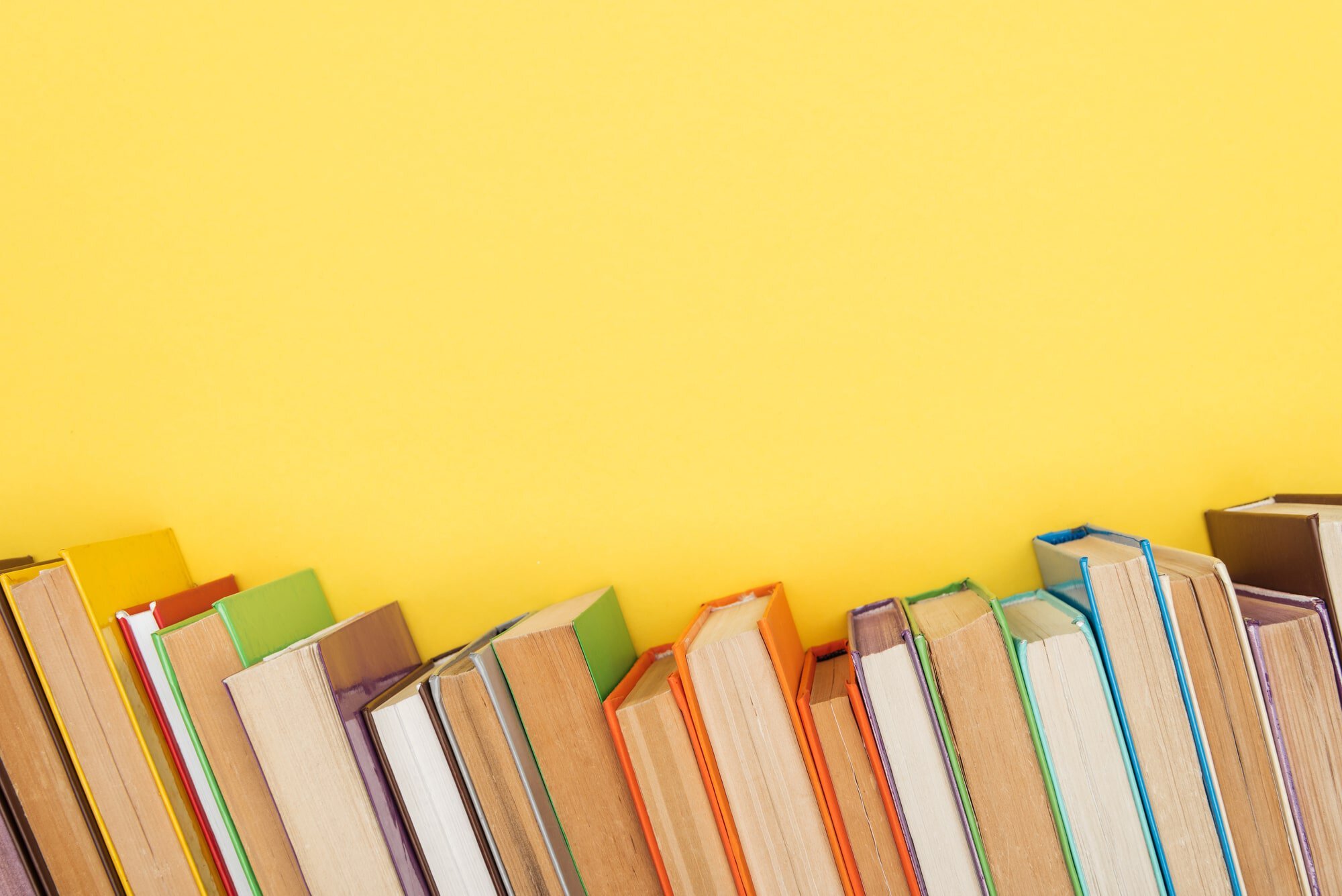 books on yellow background - How To Get Paid To Read Books