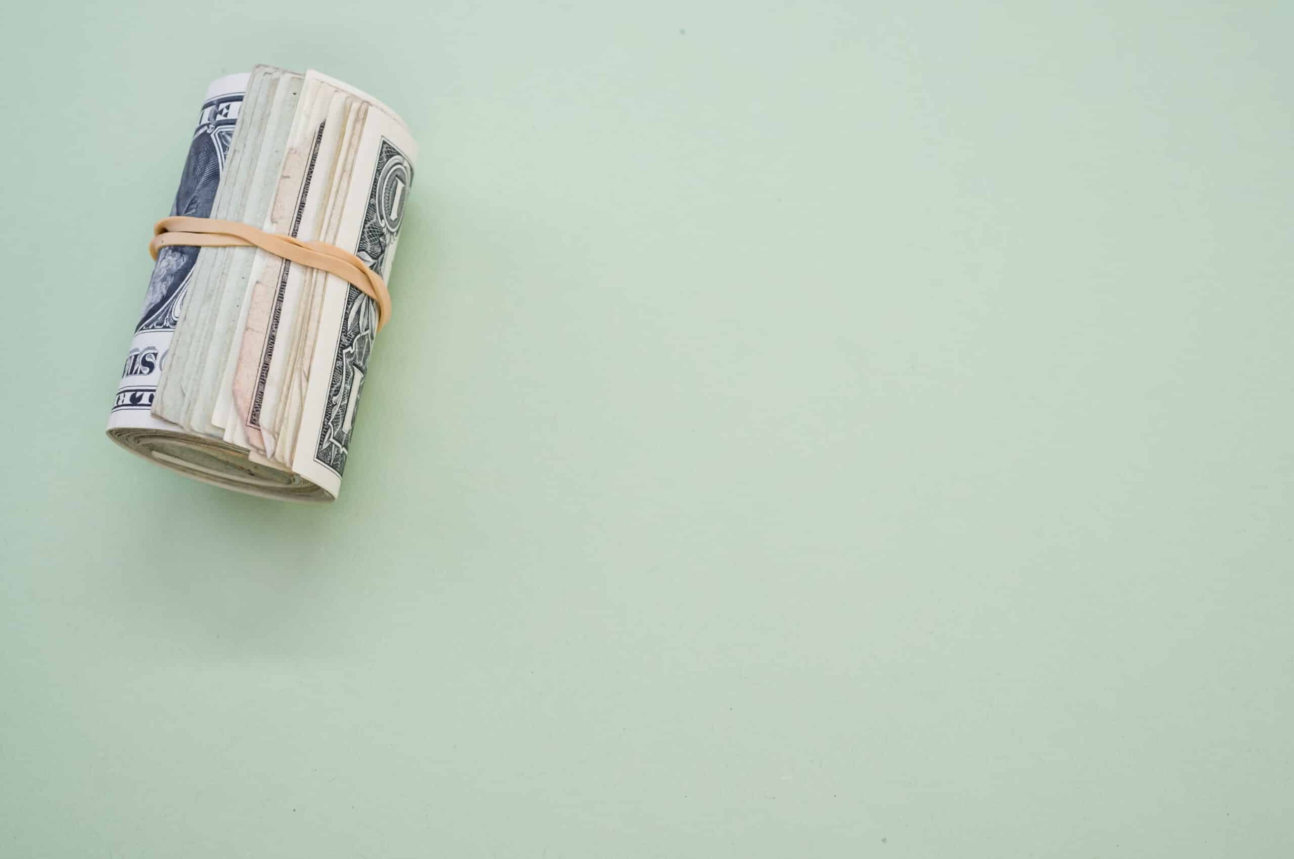 cash on green background for article how to make money selling your poop