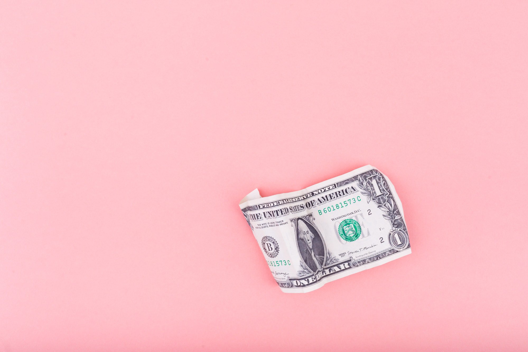 one dollar on pink background - best rewards credit cards