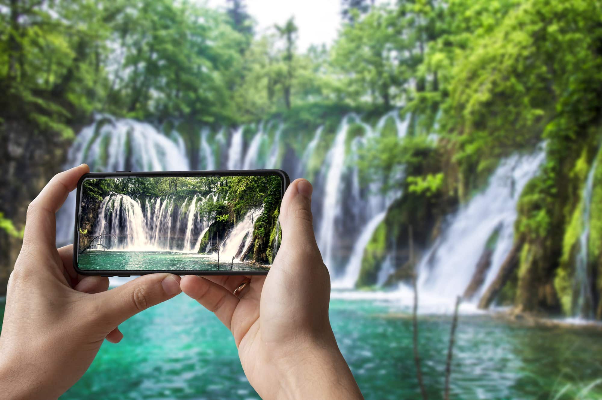 person getting paid to take picture of waterfall for stock photo website